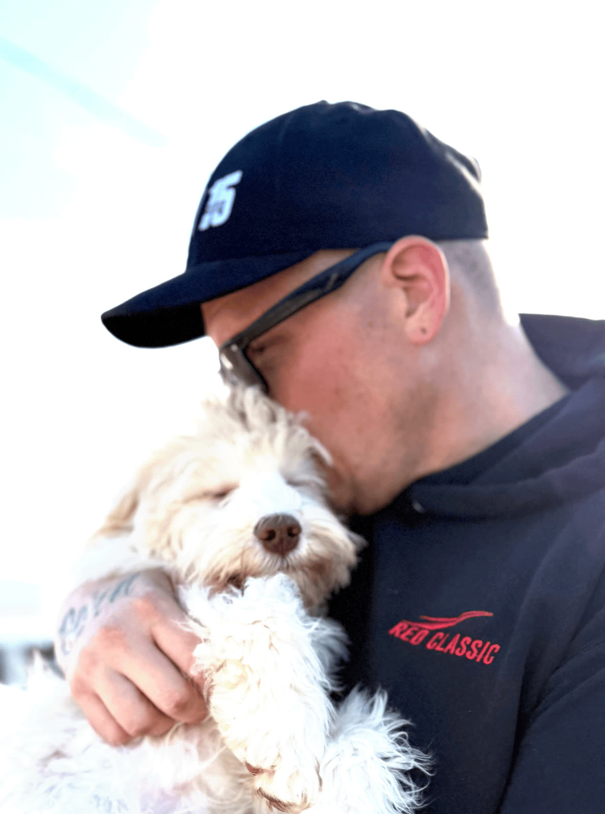 A person holding a calm companion dog close